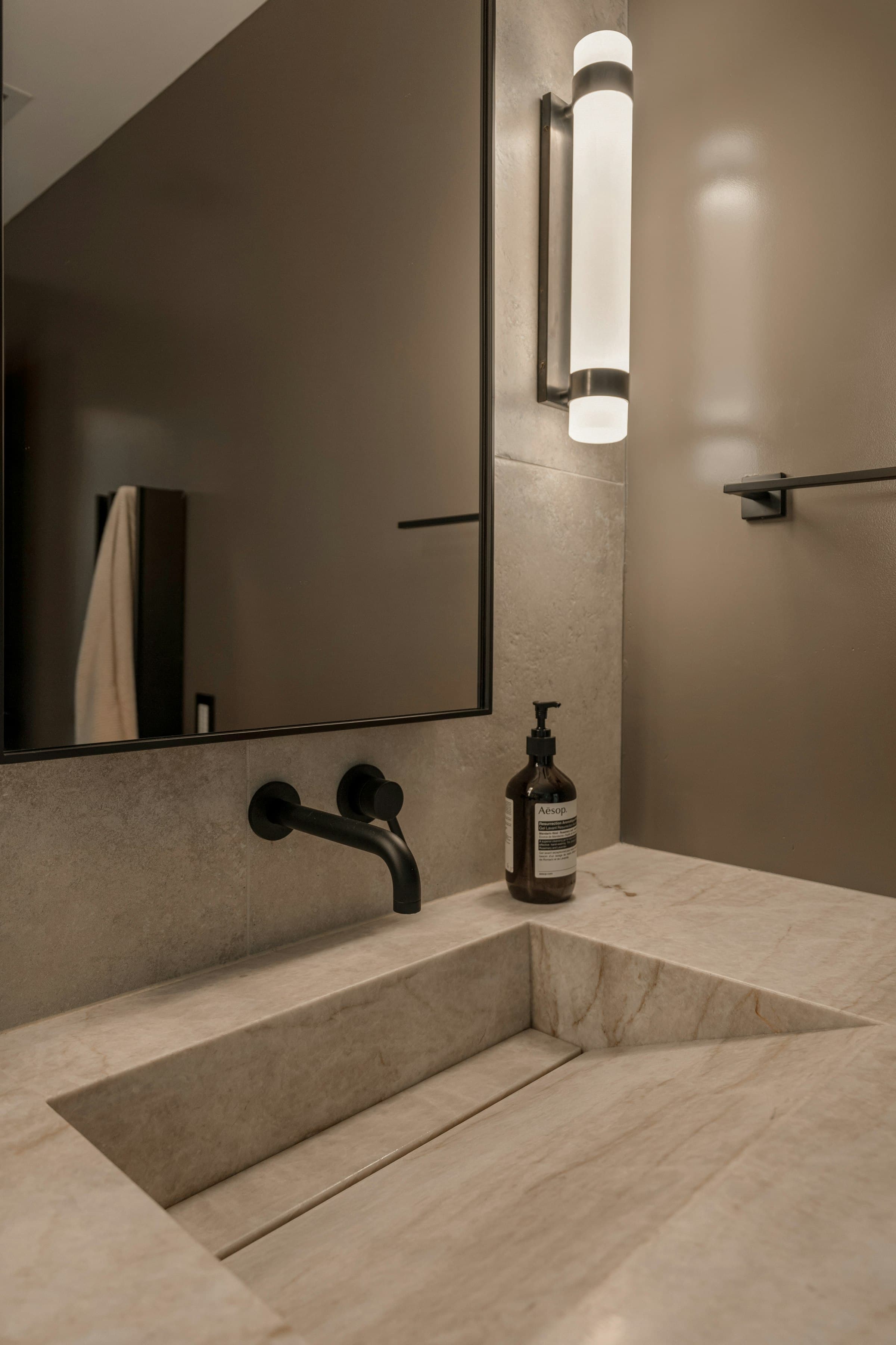 A renovated bathroom with stone and timber finishes