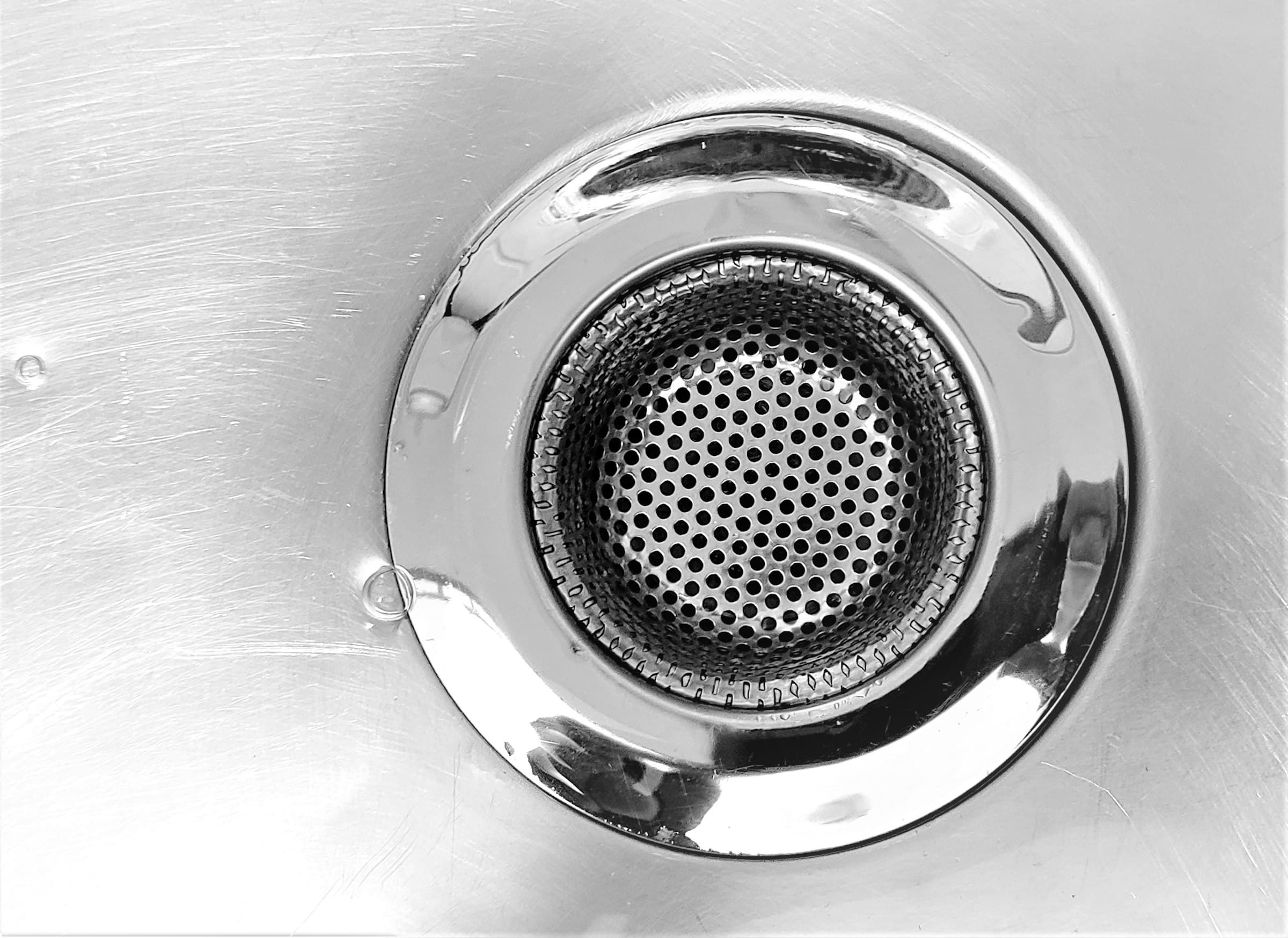 Close-up of a sink drain being inspected