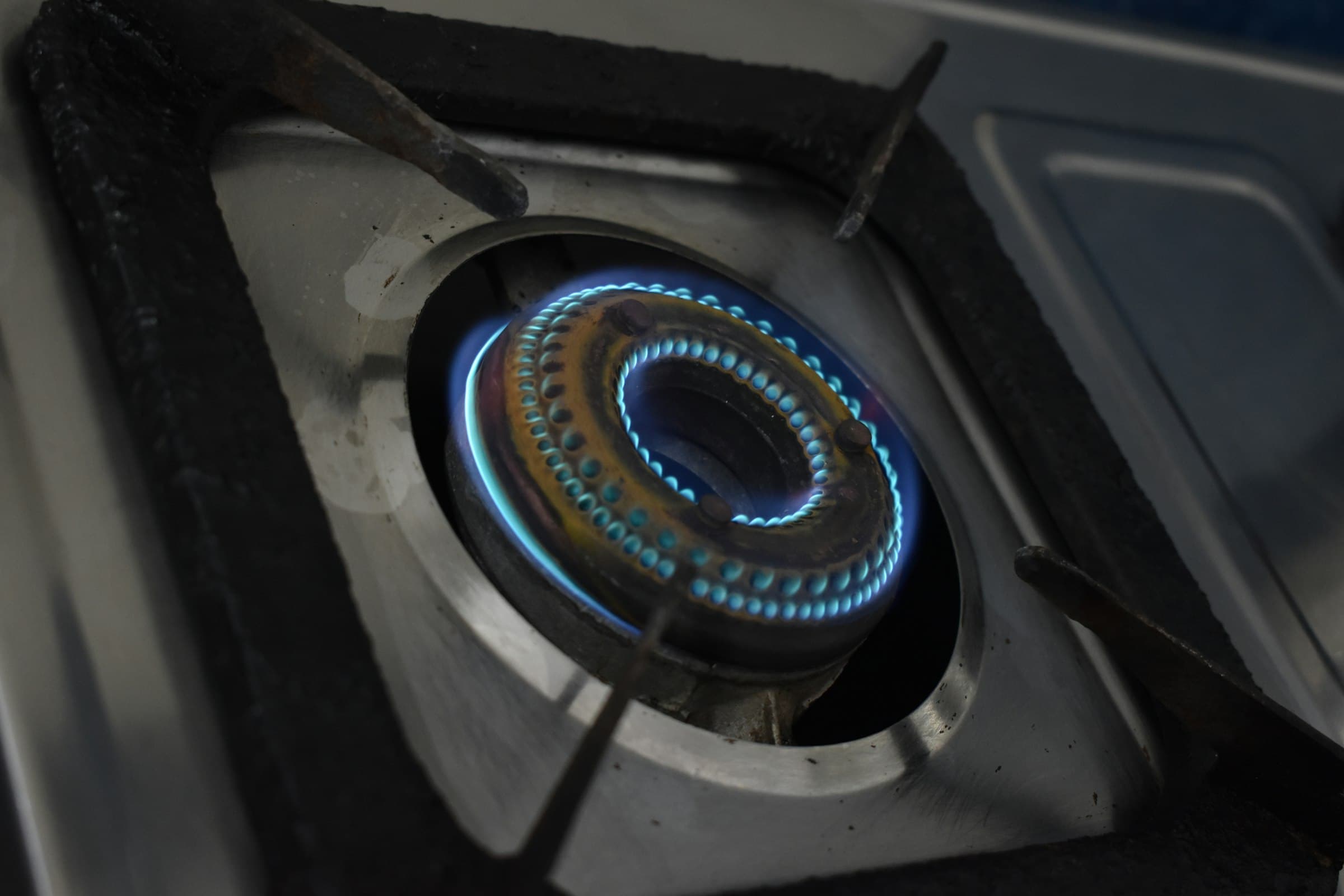 A gas burner running a clean blue flame