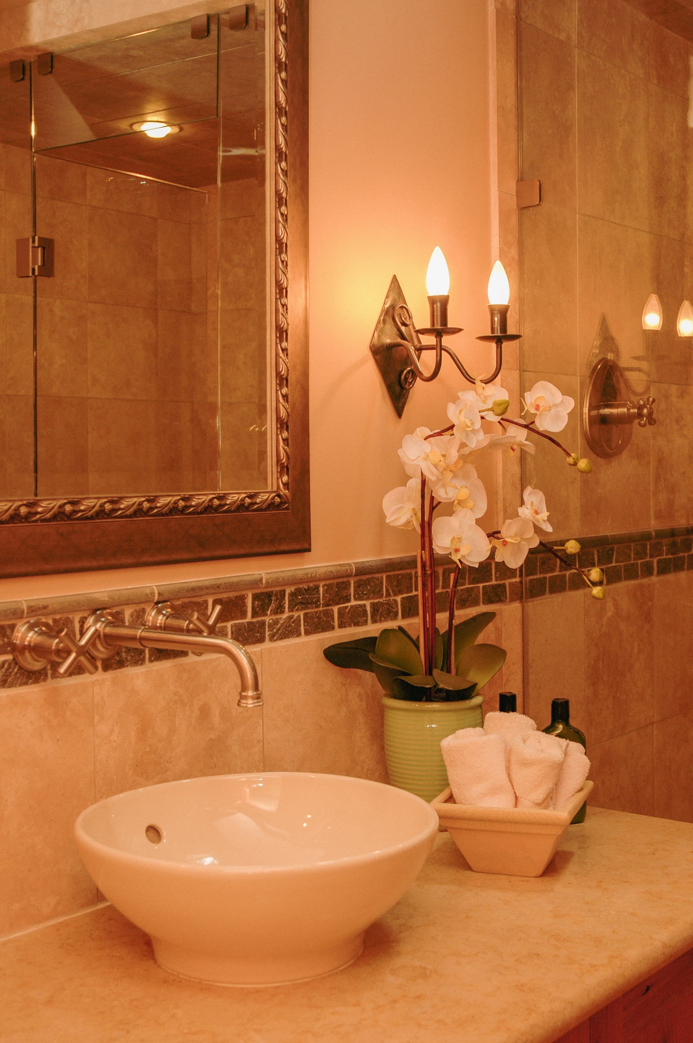 A finished bathroom with tiled walls and a freestanding basin