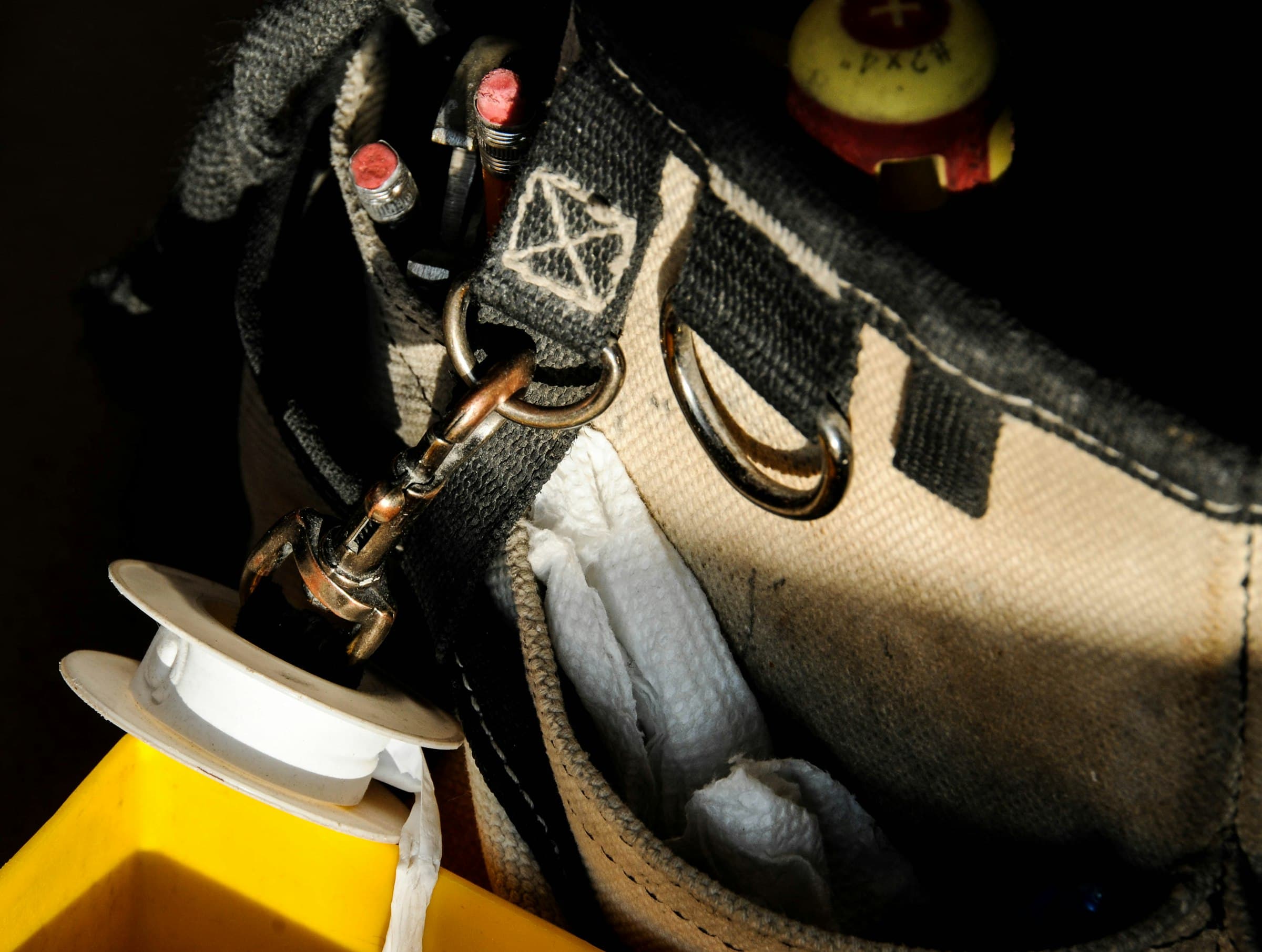 An open plumber's tool bag on a work surface