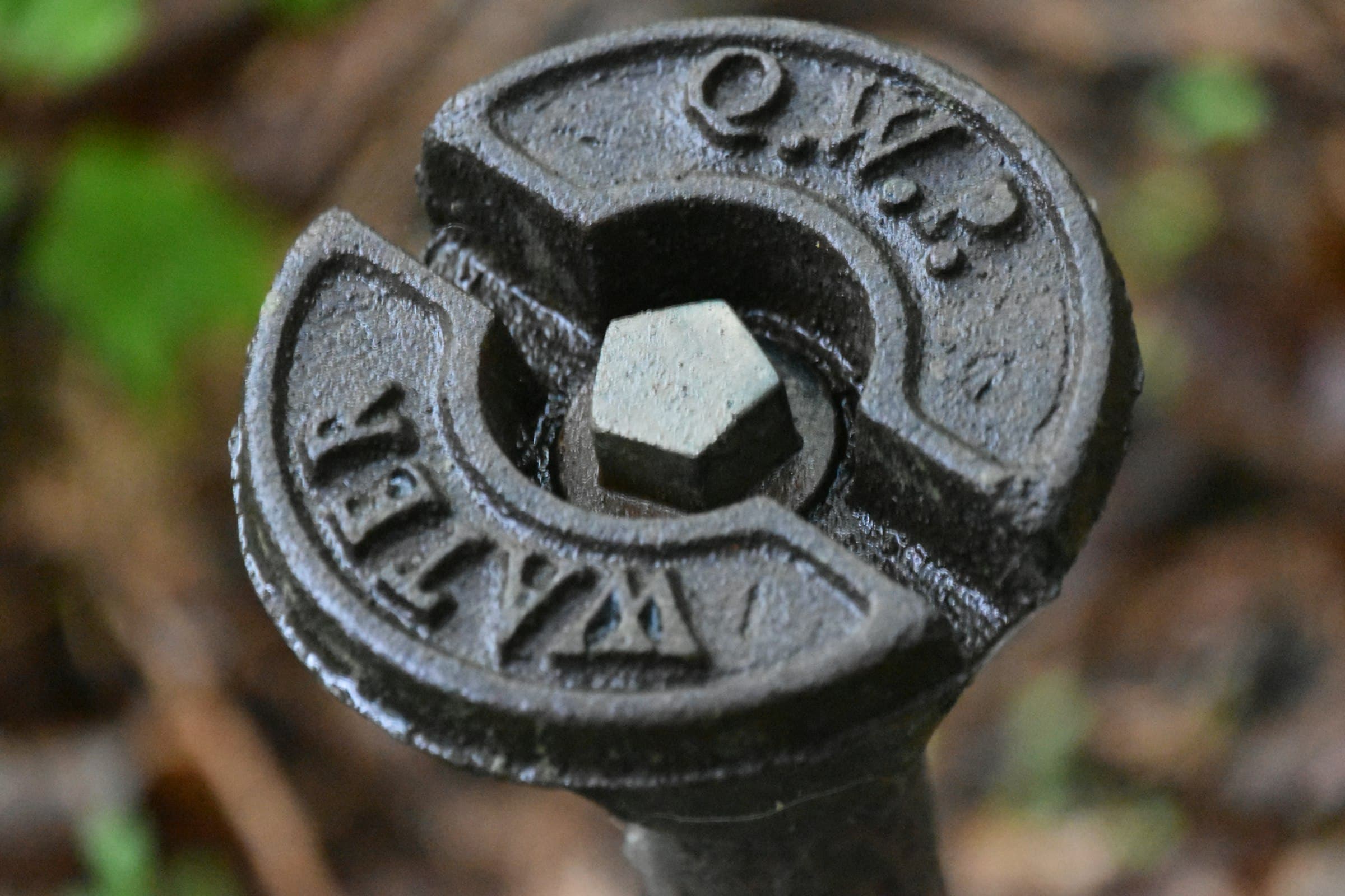 A cast iron water meter cover set into concrete