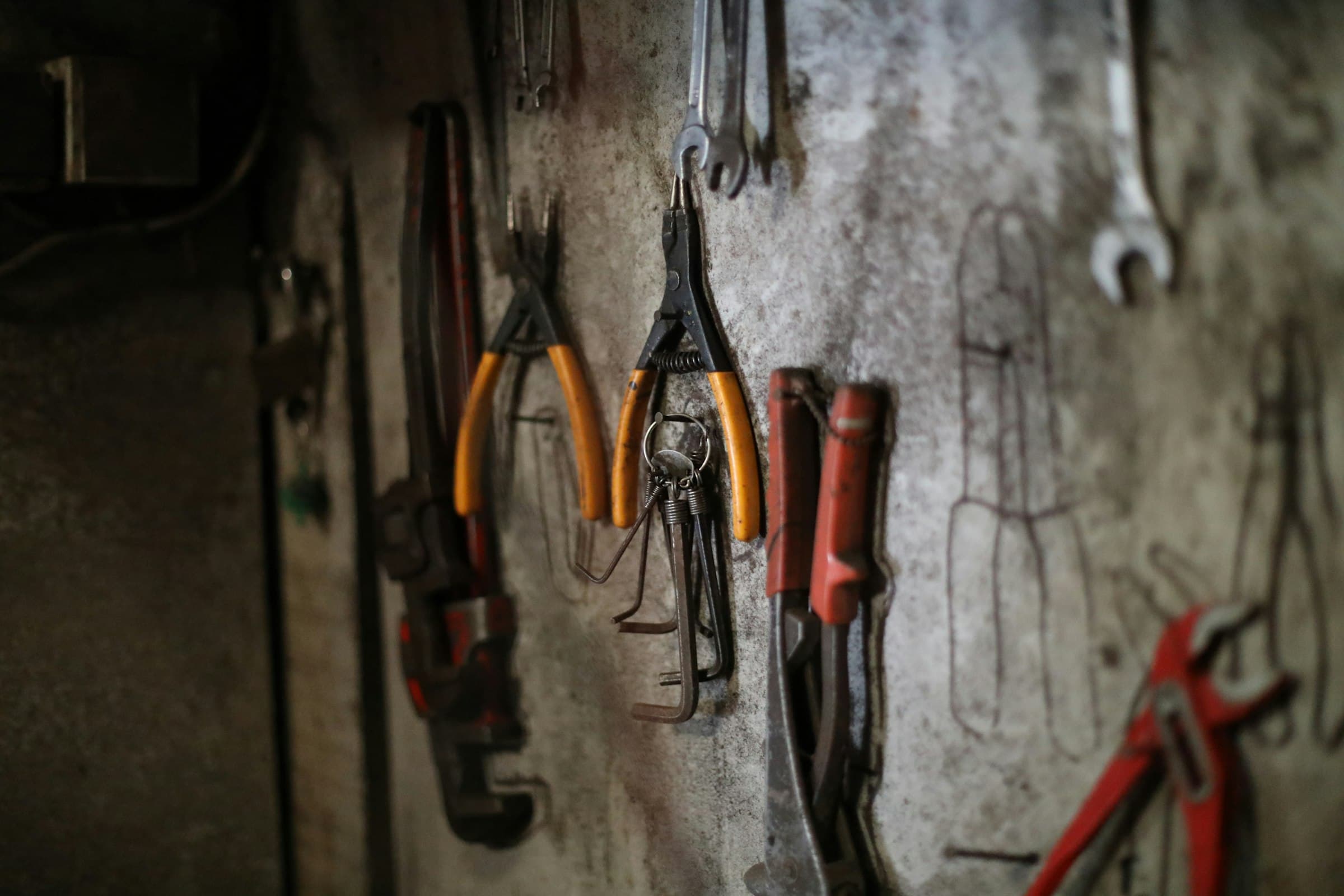 Plumbing tools laid out on a workshop bench